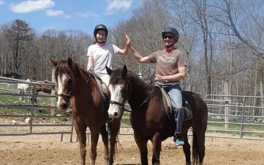 two people riding horses