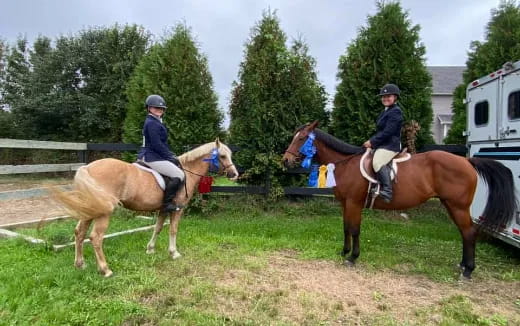 two people riding horses