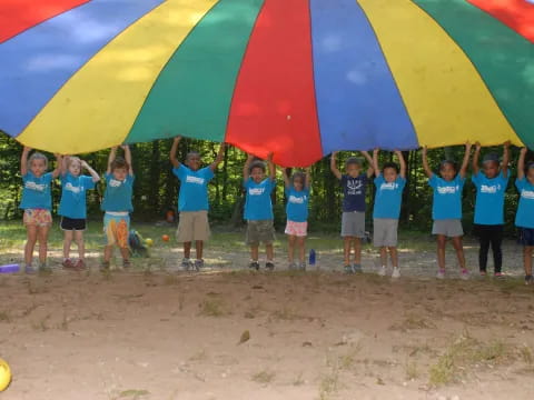 a group of children standing under a tent