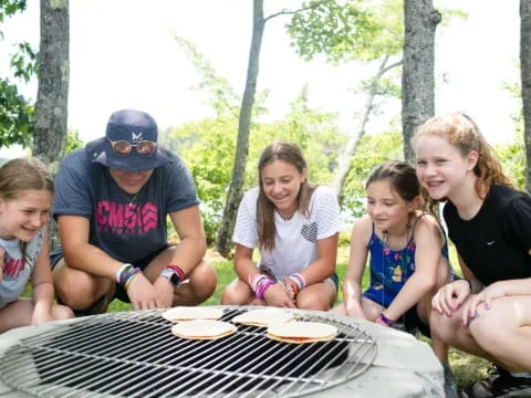 a group of people sitting around a table outside