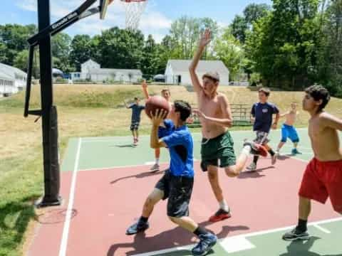 a group of boys playing basketball