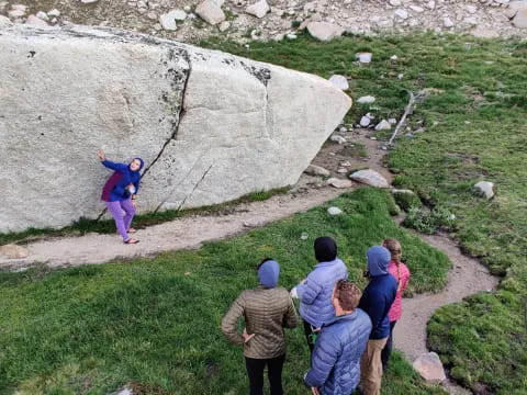 a group of people looking at a rock wall