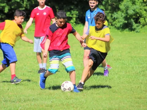 a group of kids playing football