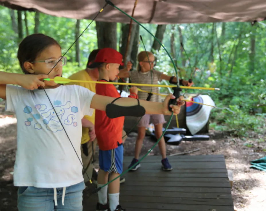 a group of kids playing with sticks