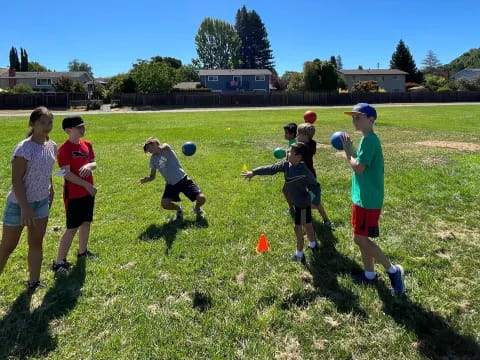 a group of kids playing with balls