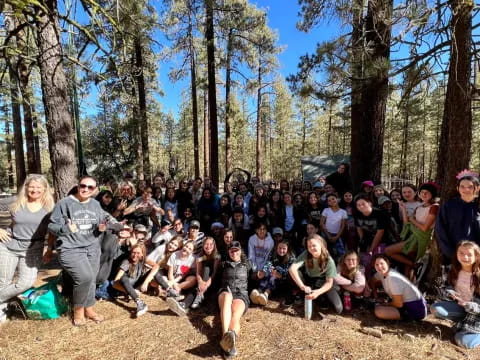 a group of people sitting in a forest