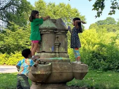 children playing with a statue