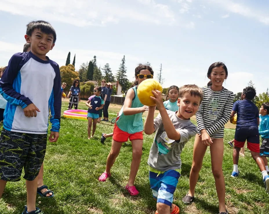 a group of kids playing with a ball