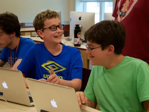 a group of boys using laptops