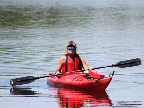 a person in a red kayak