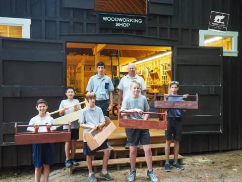 a group of people holding wooden objects