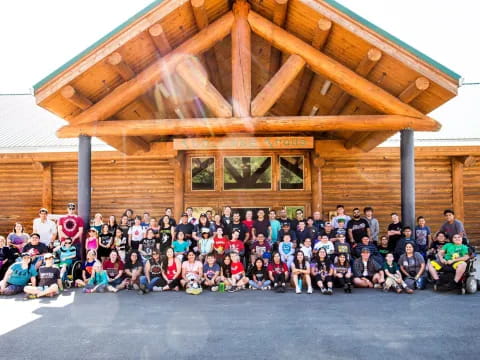 a group of people posing for a photo in front of a building