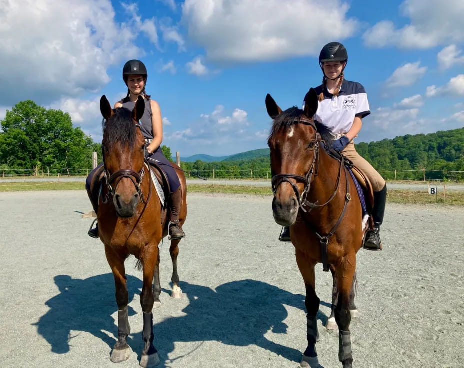 two people riding horses