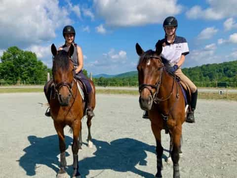 two people riding horses