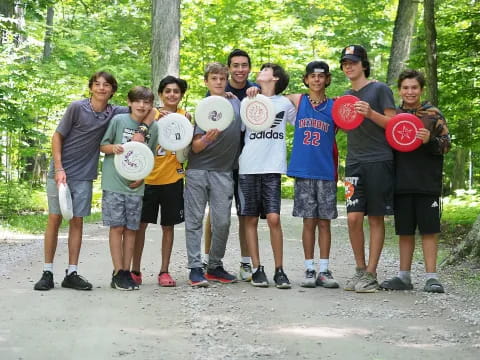 a group of people holding frisbees