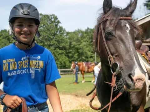 a boy with a helmet and a horse