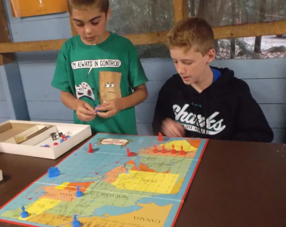 a couple of boys playing a board game