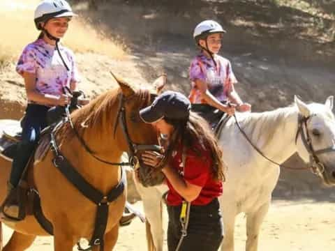 a group of people riding horses