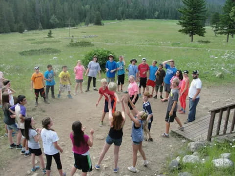 a group of people standing on a dirt path