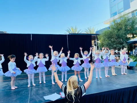 a group of girls performing on stage