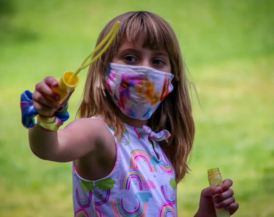 a girl holding a paintbrush