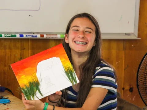 a girl holding a yellow and red paper