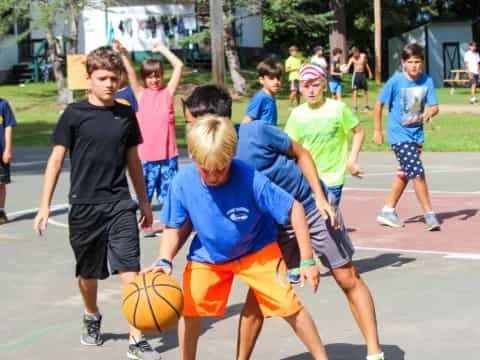 a group of kids playing basketball