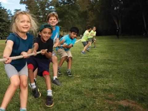 a group of kids running on a grassy field