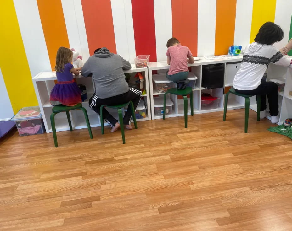 a group of people sitting at desks in a room
