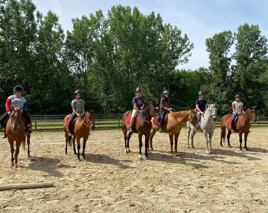 a group of people riding horses