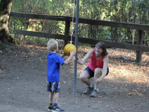 a person and a boy playing with a ball