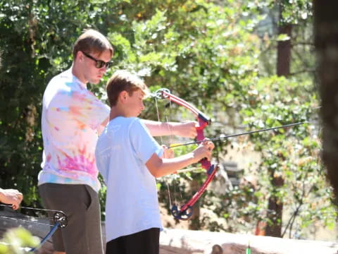 a group of people holding bows and arrows