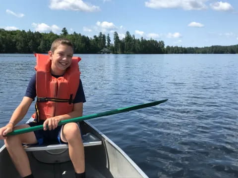a boy in a canoe