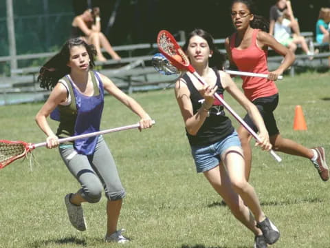 a group of women playing field hockey