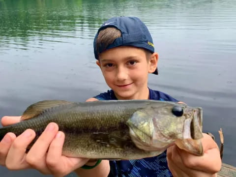 a boy holding a fish