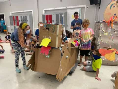 a group of children playing with a cardboard box