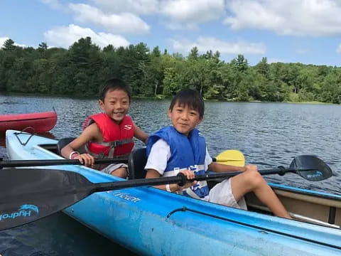 a couple of kids in a canoe