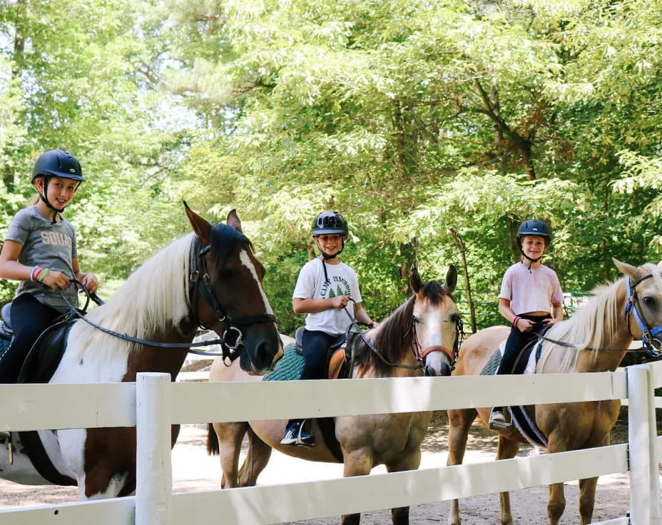 a group of people riding horses