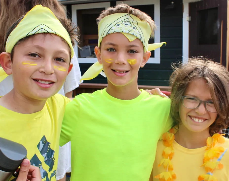 a group of children wearing yellow shirts