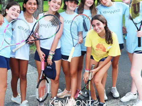 a group of women holding tennis rackets