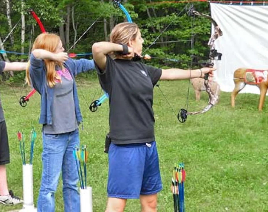 a group of people shooting bows