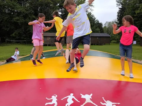 a group of kids jumping on a trampoline