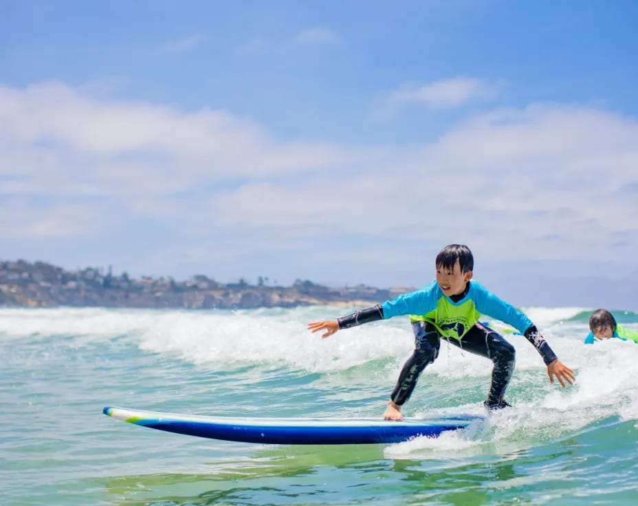 a kid surfing on the waves