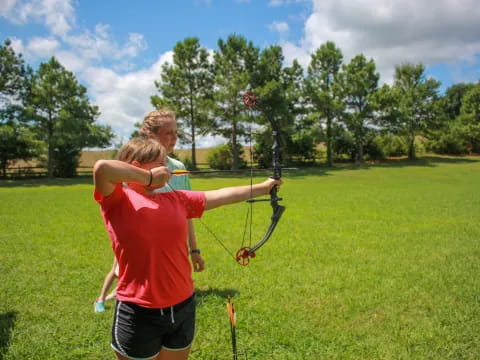 a person shooting a bow and arrow