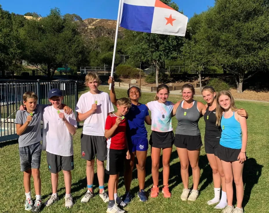 a group of people posing for a photo with a flag