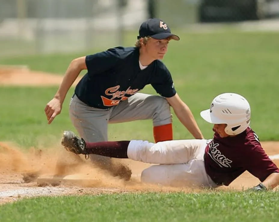a baseball player sliding into second base