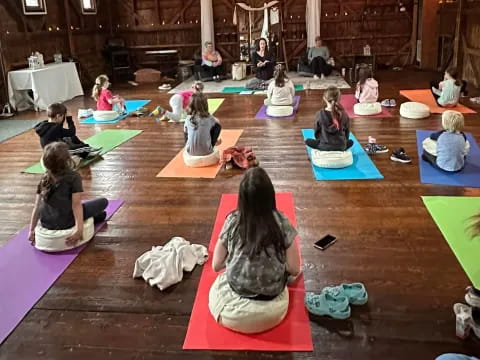 a group of people sitting on mats