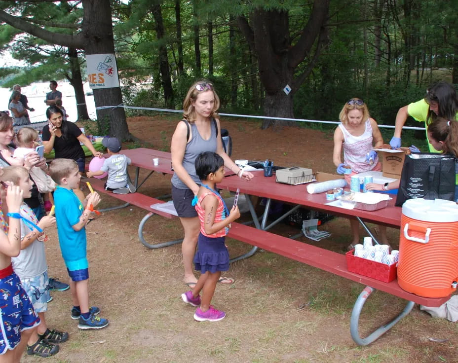 a group of children at a picnic table