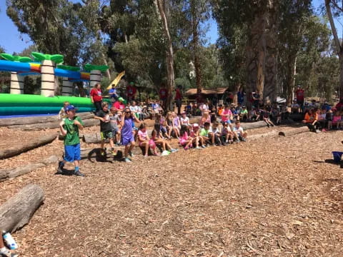 a group of people sitting on the ground