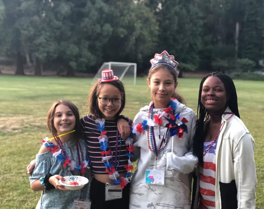 a group of girls wearing sashes and holding a trophy